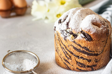 Modern pastries vanilla and chocolate cruffin whole and slice like croissant and muffin with powder sugar served with a cup of coffee.