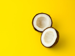Coconut on yellow colored background, flat lay, top view
