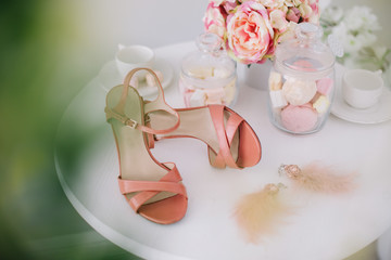 Pink women shoes, a bouquet of spring flowers and marshmallows on white background. Morning of the bride. Concept of holiday, birthday, Easter, March 8. flat lay 