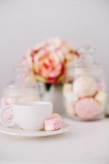 White cup with marshmallows on white background. Romantic breakfast. Concept of holiday, birthday, Easter. flat lay