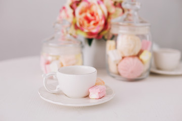 White cup with marshmallows on white background. Romantic breakfast. Concept of holiday, birthday, Easter. flat lay