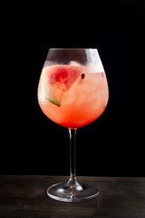 Freshly served watermelon cocktails with alcohol. On a black background.