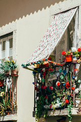 Fototapeta na wymiar Flowers Balcony On City Street In Lisbon, Portugal