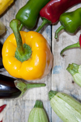 red and green peppers on wooden table