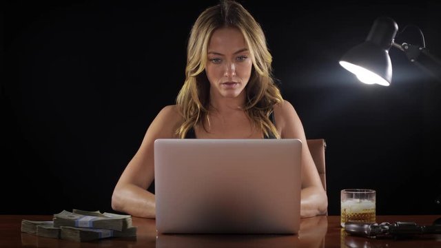 Dangerous and sexy woman working at a laptop.