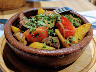 Traditional Georgian family meal ojakhuri, fried meat with potatoes in ceramic pot, delicious cuisine