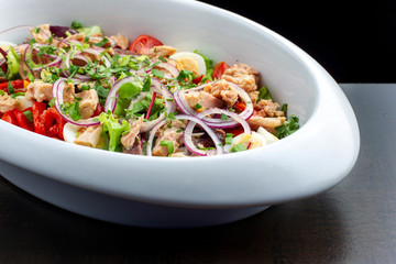 Salad with herring, greens, boiled eggs and pepper.