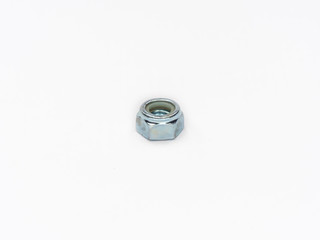 Zinc plated self locking hexagonal metric stop nut on white.