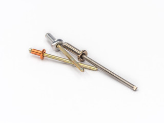 Mixed flat pop rivets with mixed mandrels on white.