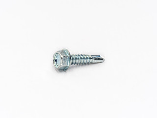 Zinc plated hexagonal head self drilling point screw bolt shot on white.