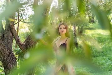 Young attractive girl in summer dress posing outdoor