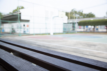 Fototapeta premium empty old wooden bleachers with blurred basketball court background.
