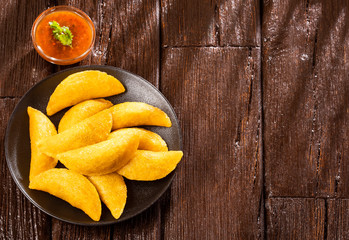 Colombian empanada with spicy sauce