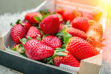 Beautiful ripe strawberries for sale on a tray in wooden containers. without plastic. Plastic-free packaging
