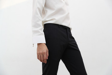 close-up of A handsome man in white V-neck shirt and black long trousers.