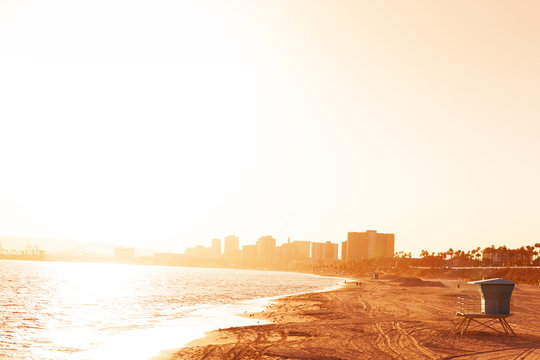 Deserted sea shore of Long Beach at sunset