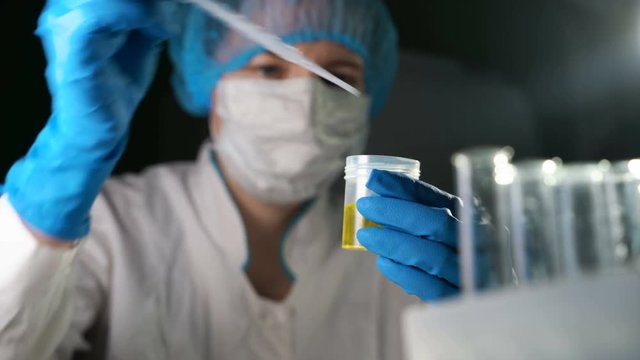 Doctor examining an urine sample.