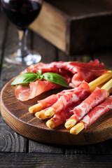 Bread sticks grissini with prosciutto