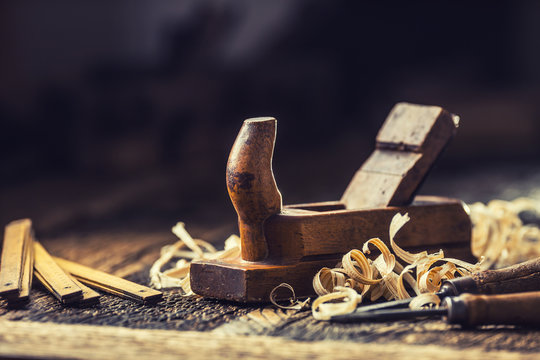 Old planer and other vintage carpenter tools in a carpentry workshop