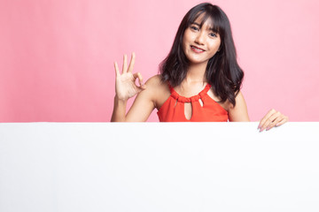 Fototapeta premium Young Asian woman show OK with blank sign.