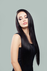 Stylish young woman brunette with long healthy perfect straight hair and makeup