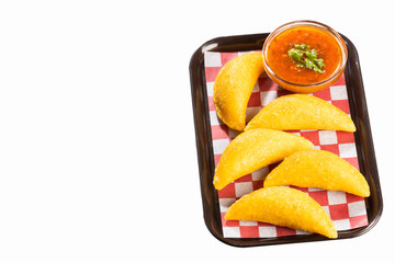 Colombian empanada with spicy sauce