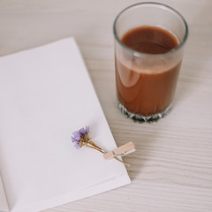 A book with a glass of coffee. A diary with morning tea. Spring still life. Sweet home. Good morning. flat lay