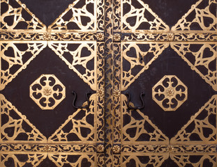 closeup of antique church door with golden ornate