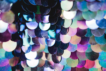 Shiny abstract background of semicircular multi-colored plastic elements of sequins texture...