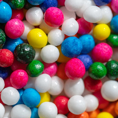 Fototapeta na wymiar Super Macro of colorful sweets candies balls background