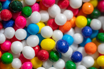 Fototapeta na wymiar Super Macro of colorful sweets candies balls background