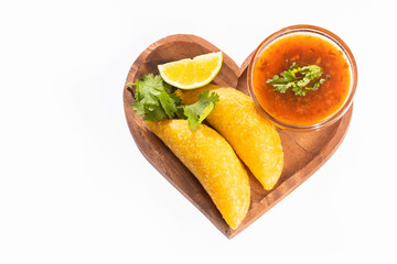 Colombian empanada with spicy sauce