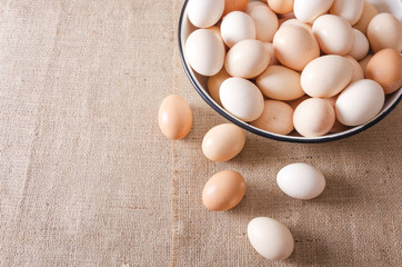 Top view of bowl with eggs on the sackcloth.Farm concept.Empty space for your design