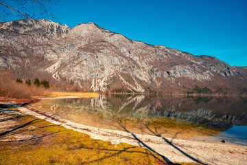 Rocky shore of the mountain lake. Beautiful nature. Reflection on the lake