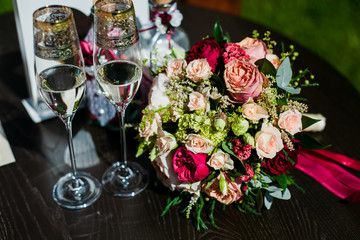 wedding bouquet and wine glasses