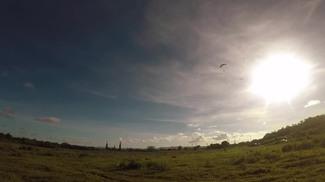 Soldiers arriving by parachute in an open field 1