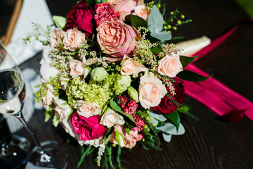 wedding bouquet and wine glasses