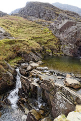 Obraz premium Waterfall on the Cwmorthin Waterfall trail in the mountains of Snowdonia National Park, Wales.