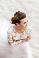 portrait of the bride on the background of the sea in windy weather