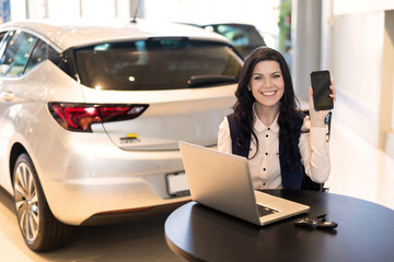 Portrait of stylish insurance agent holding a card