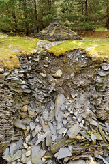 Stream trough reinforced by rocks on the Cwmorthin Waterfall trail in the mountains of Snowdonia National Park, Wales.