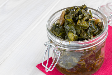 seaweed salad on light wooden background with space for text