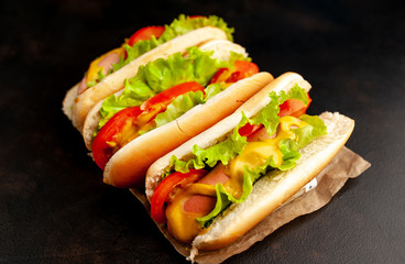 delicious hot dogs on a cutting board against a background of stone