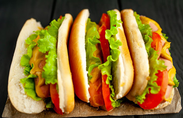 delicious hot dogs on a dark wood background