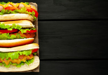 delicious hot dogs on a dark wood background with copy space for your text