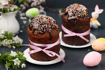 Still life with Easter cakes covered with chocolate icing and colorful eggs
