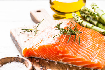 Fresh fish salmon with lemon sea salt and rosemary on white.