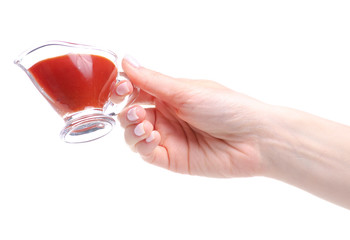 sauceboat tomato in hand on white background isolation