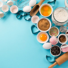 Ingredients and utensils for baking, blue background