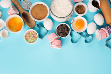 Ingredients and utensils for baking, blue background